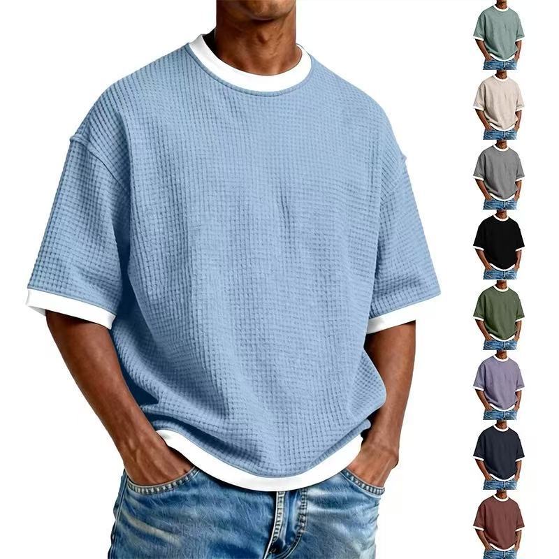 Man wearing a blue textured t-shirt with white trim, surrounded by smaller images of the same shirt in various colors.