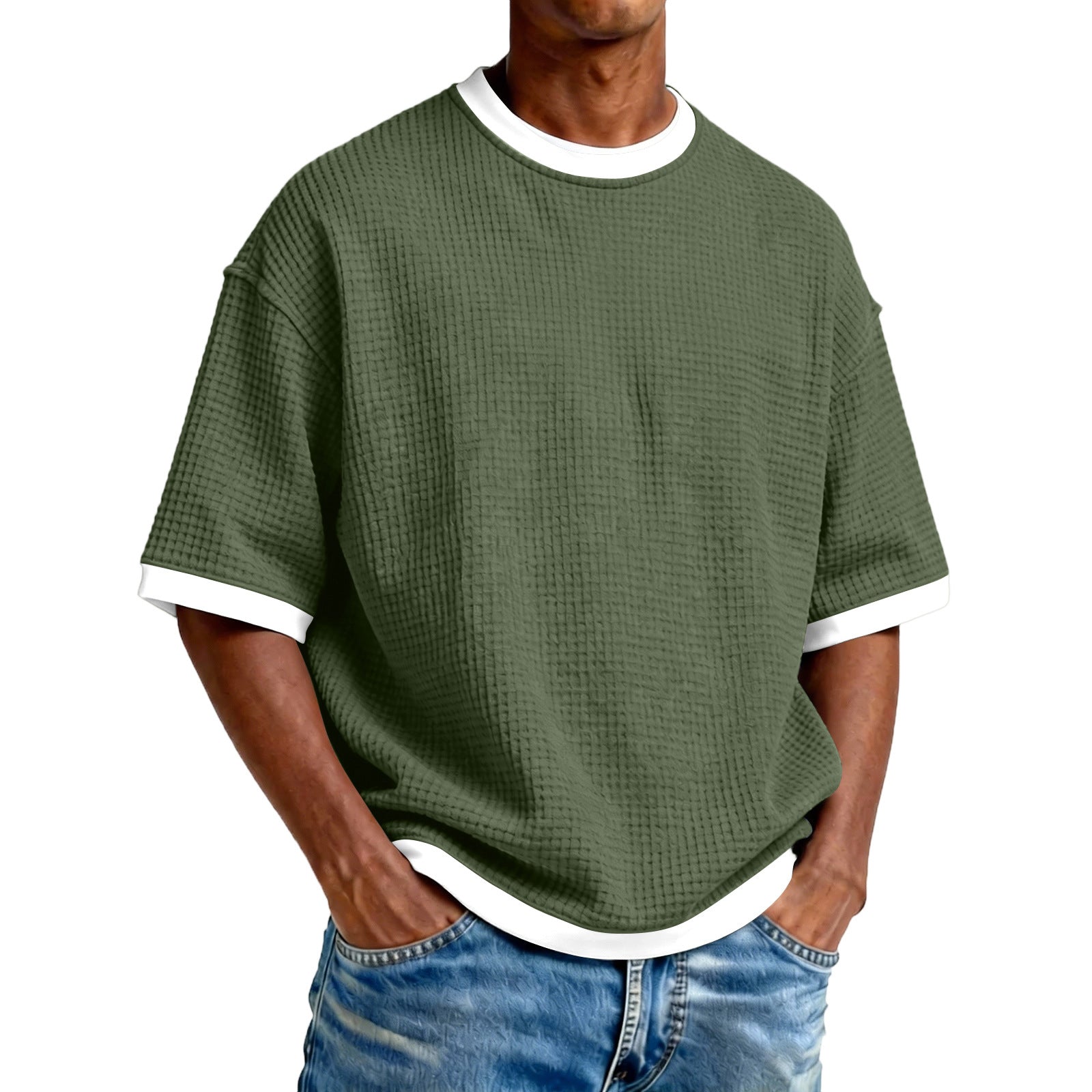 Person wearing a green textured t-shirt with white trim on a white background