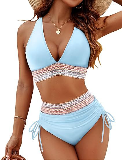 Woman wearing a light blue and white striped swimsuit with a straw hat.