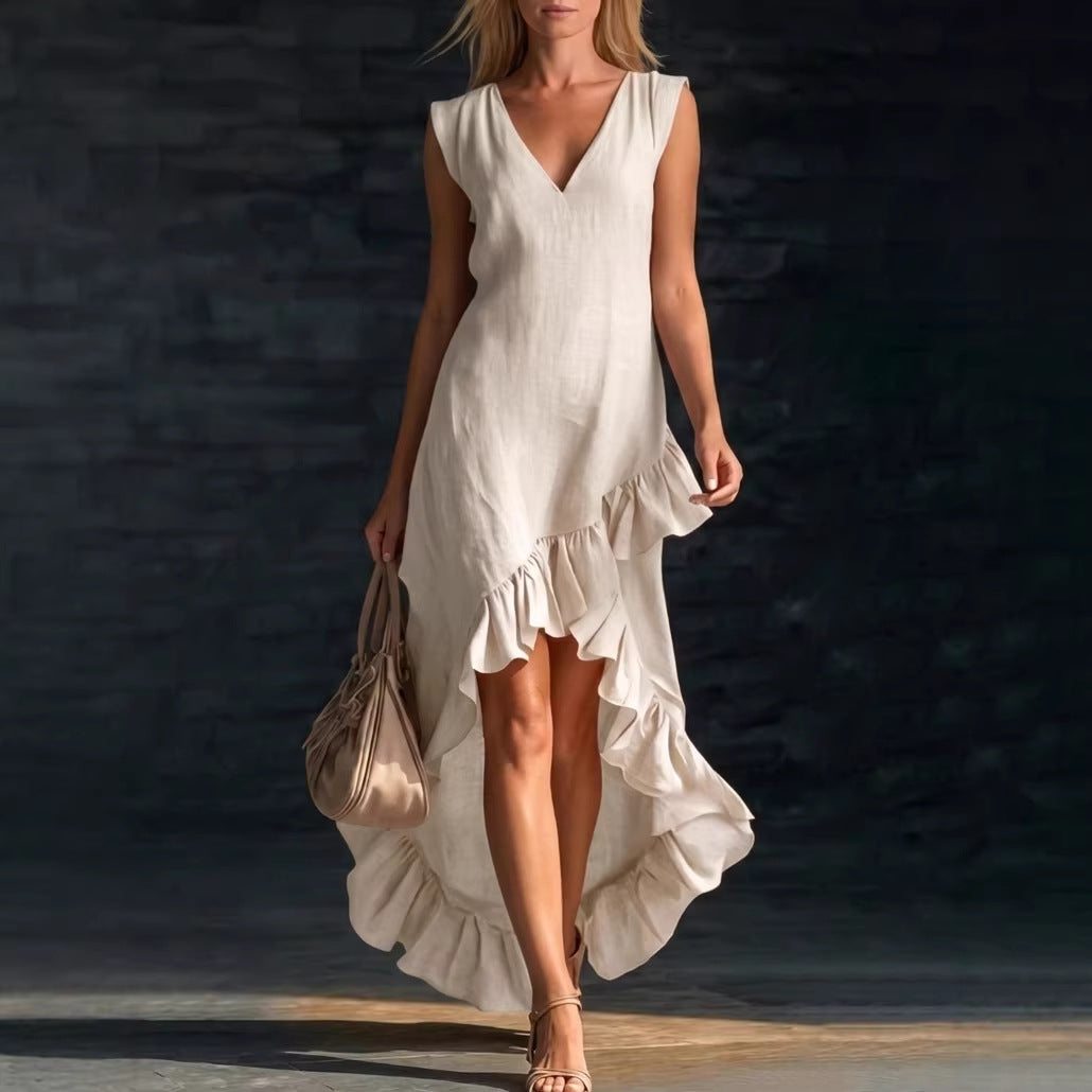 Woman wearing a white dress with ruffles against a dark background