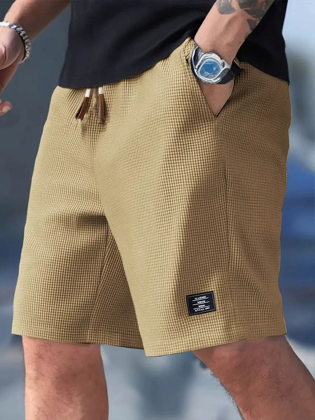 Beige checkered shorts worn by a person with a blurred background