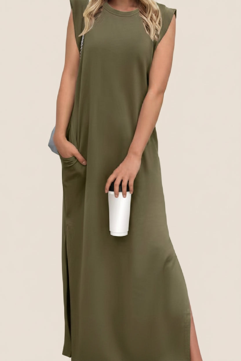 Woman wearing an olive green sleeveless dress holding a white cup on a white background