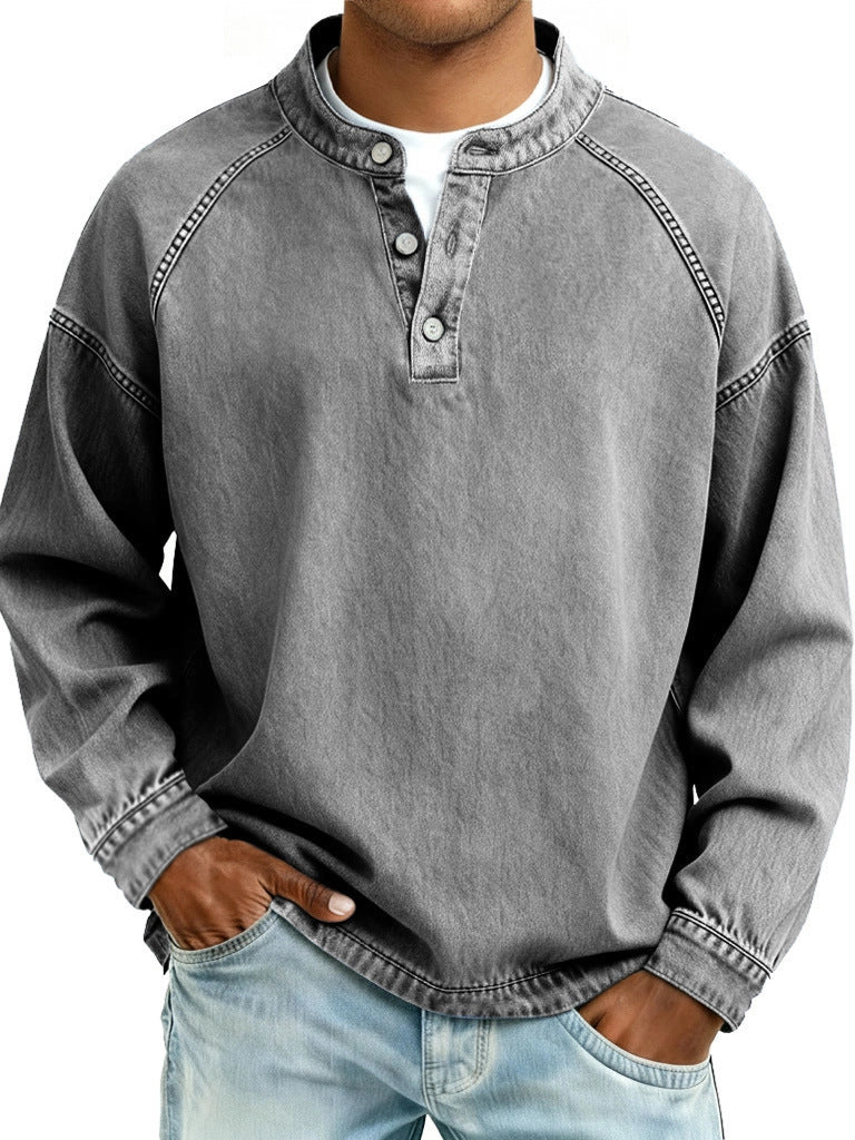 Person wearing a gray long-sleeve shirt with button details on a white background