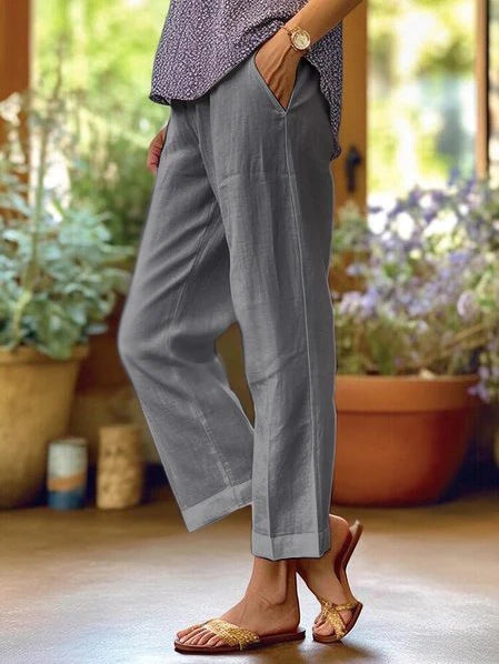 Person wearing gray pants with a blurred indoor background