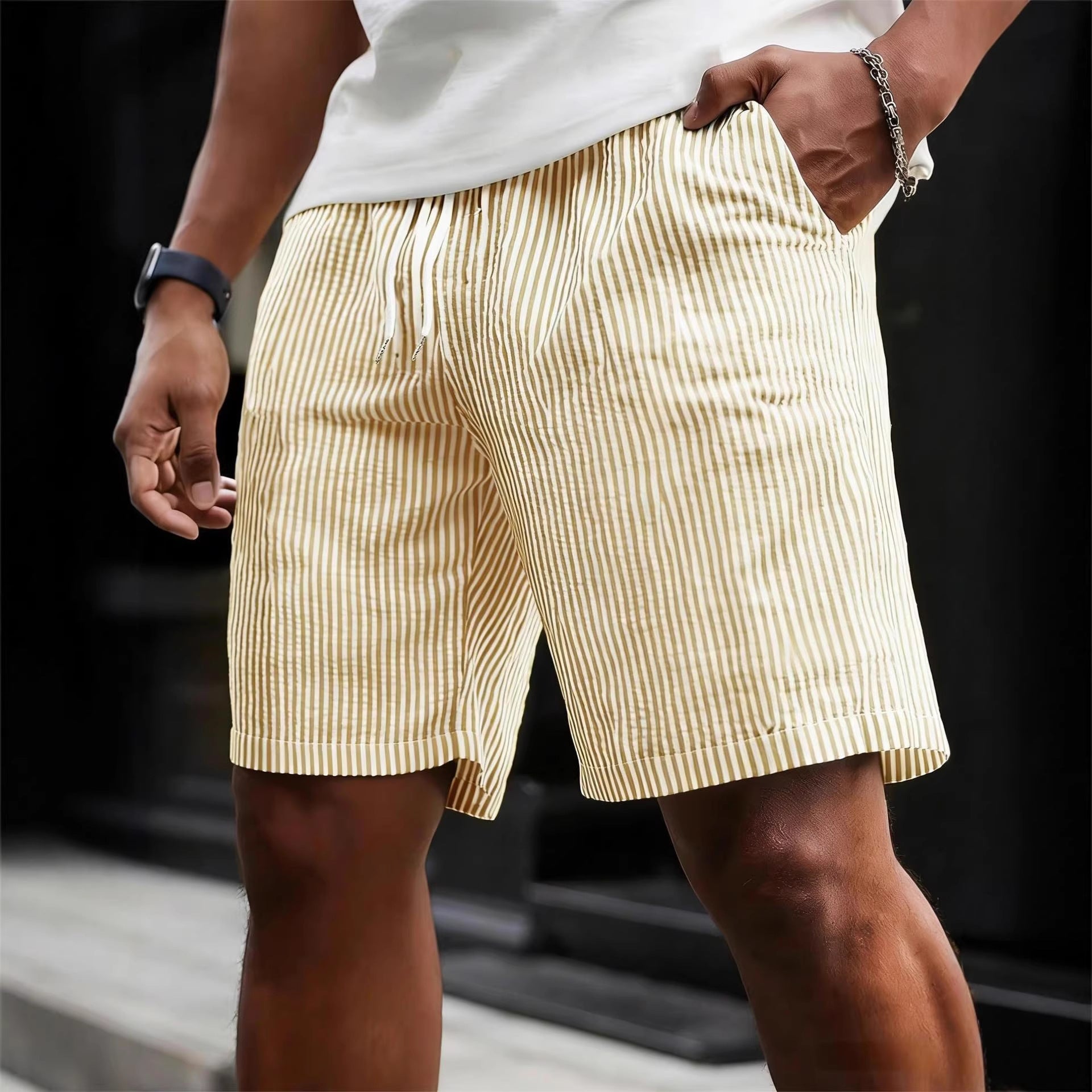 Person wearing yellow striped shorts with a blurred background