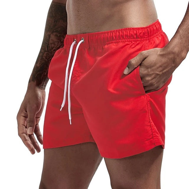 Red swim shorts with a white drawstring on a white background