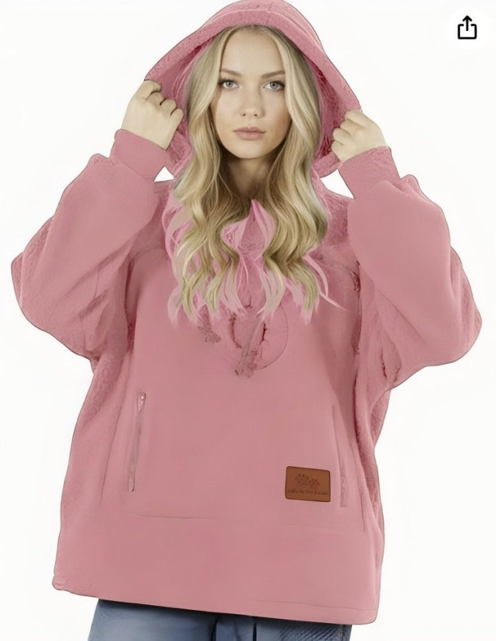Person wearing a pink hooded jacket on a white background