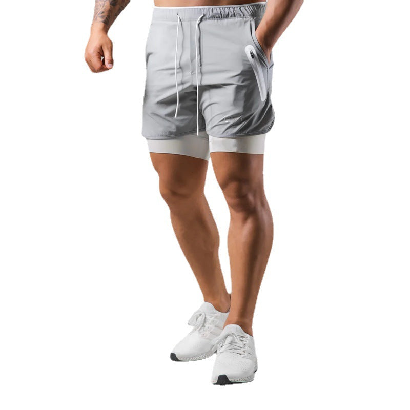 Person wearing gray athletic shorts on a white background