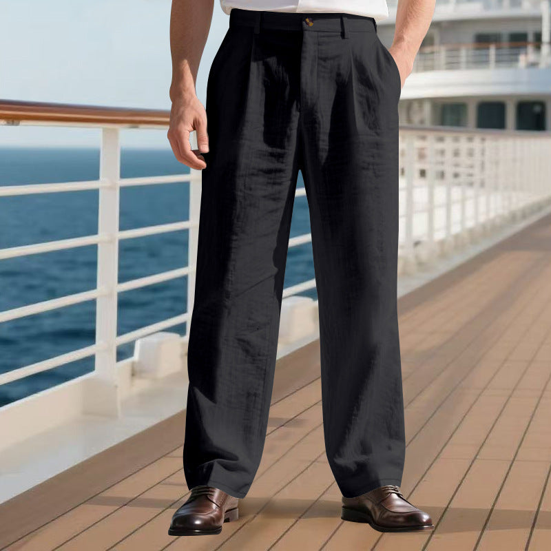 Person wearing black pants standing on a cruise ship deck with ocean view