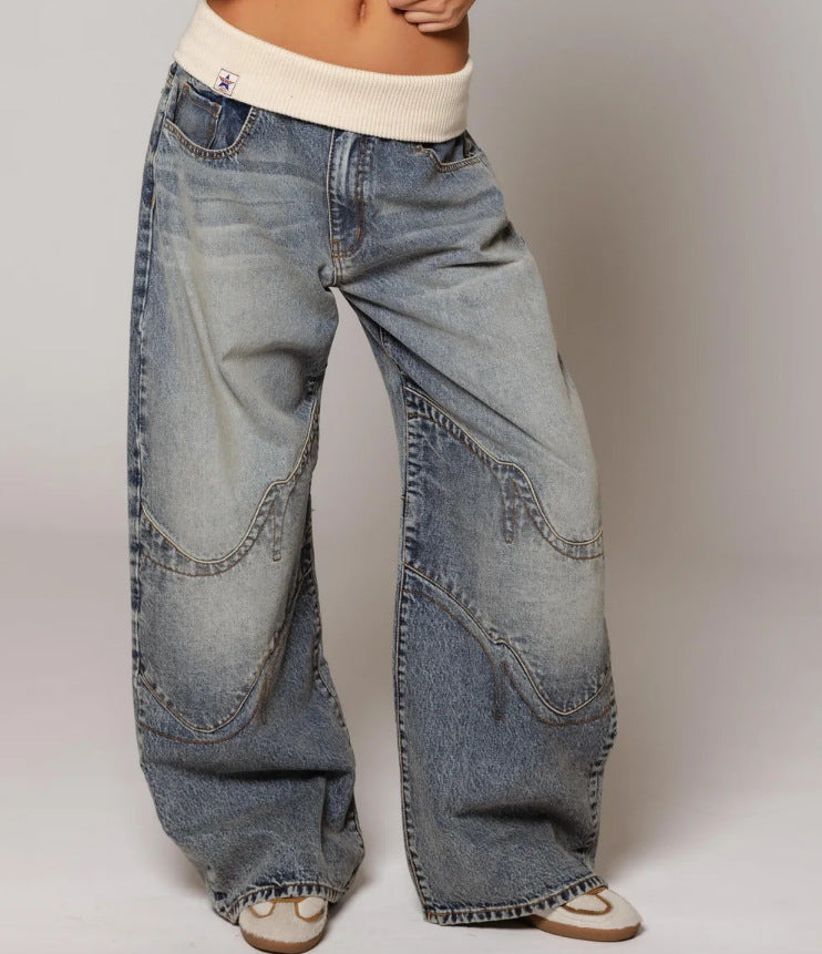 Wide-leg jeans worn by a person on a plain background