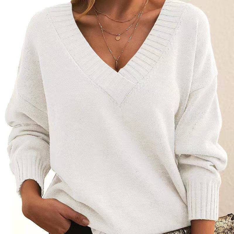 White sweater worn by a person with a neutral background