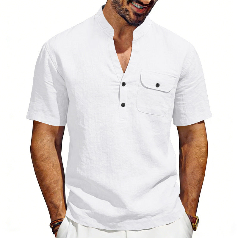 Man wearing a white short-sleeve shirt with black buttons on a white background