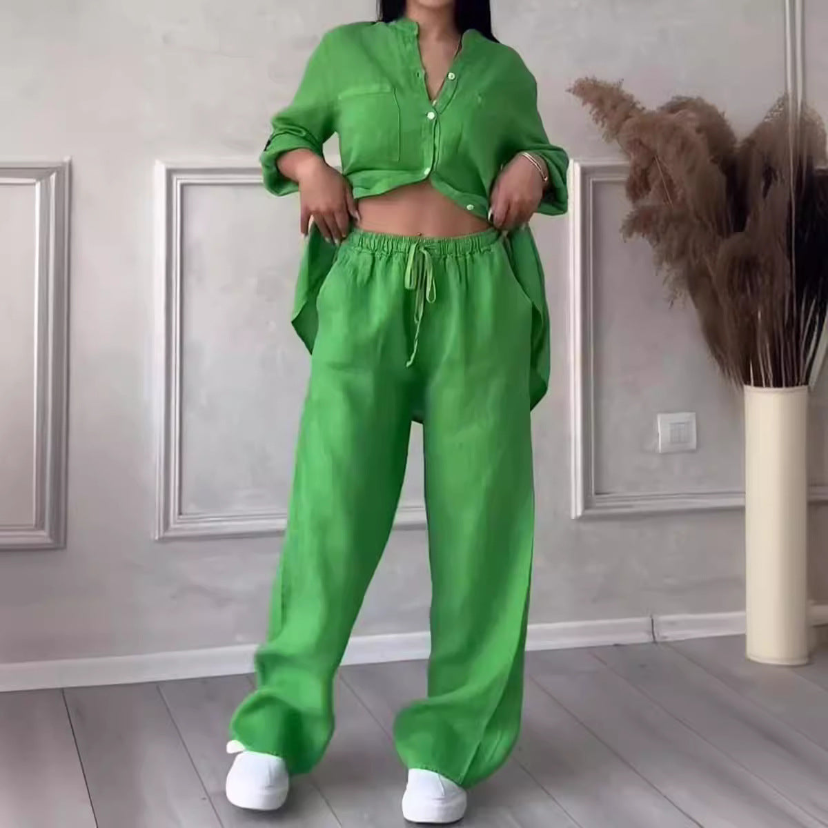 Person wearing a bright green outfit in a room with decorative elements.