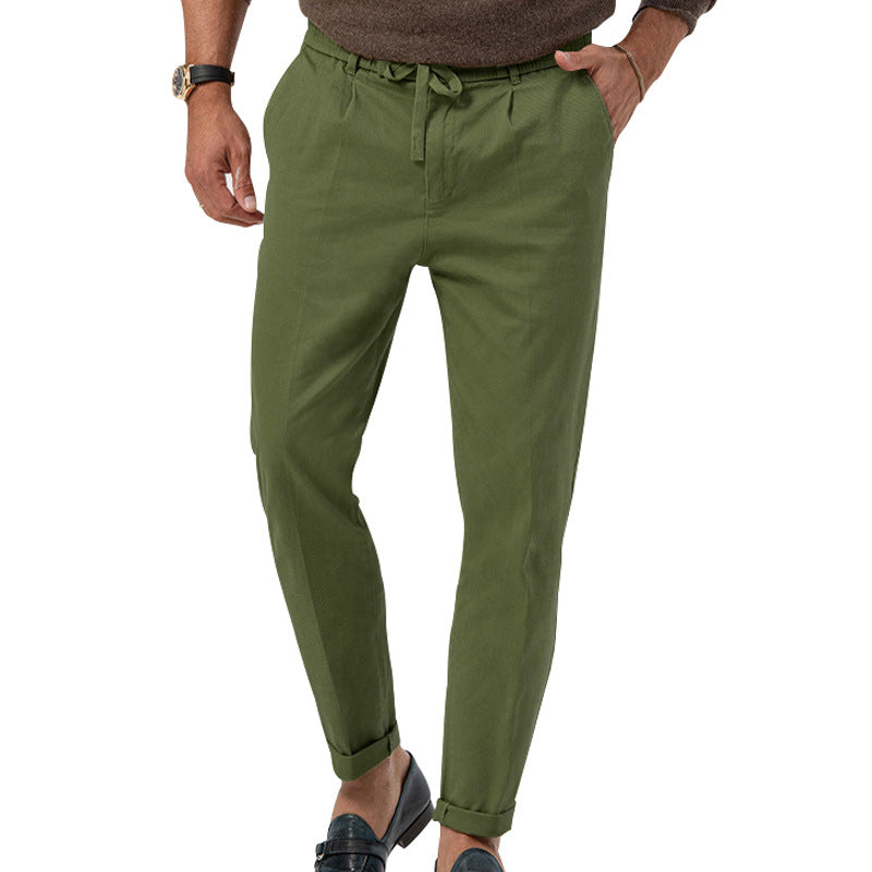 Green pants worn by a person on a white background