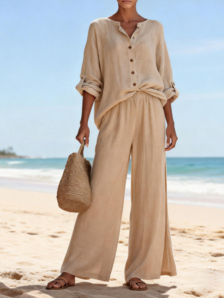 Woman in beige outfit holding a straw bag on a beach