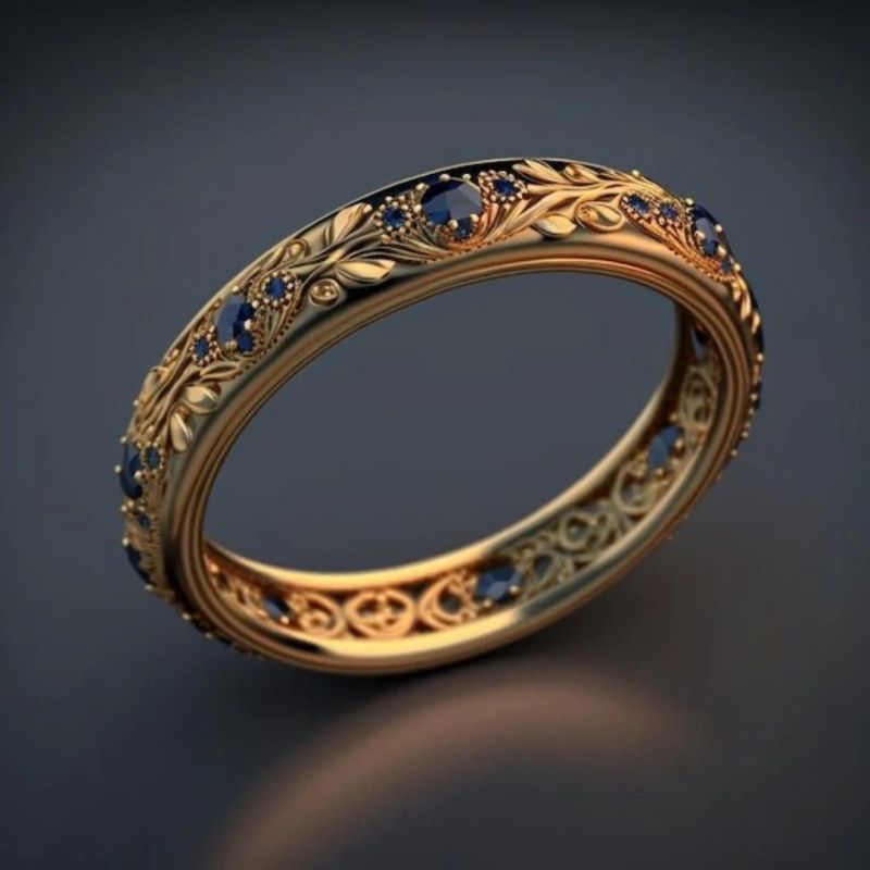 Gold ring with blue gemstones on a dark background