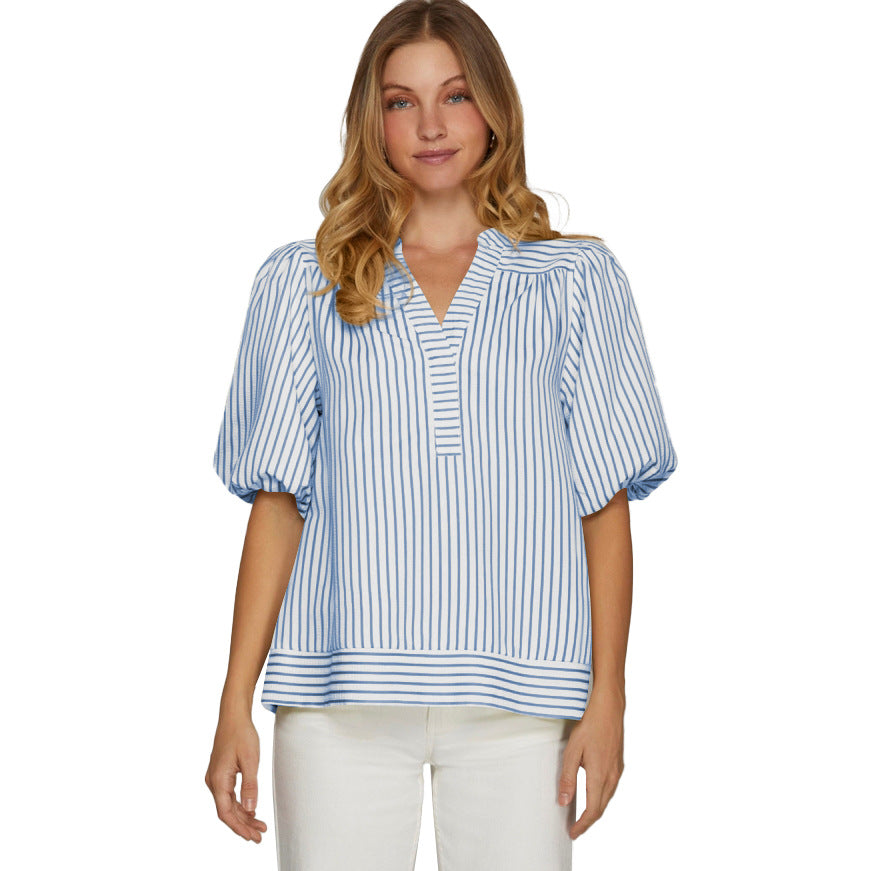 Woman wearing a blue and white striped blouse on a white background
