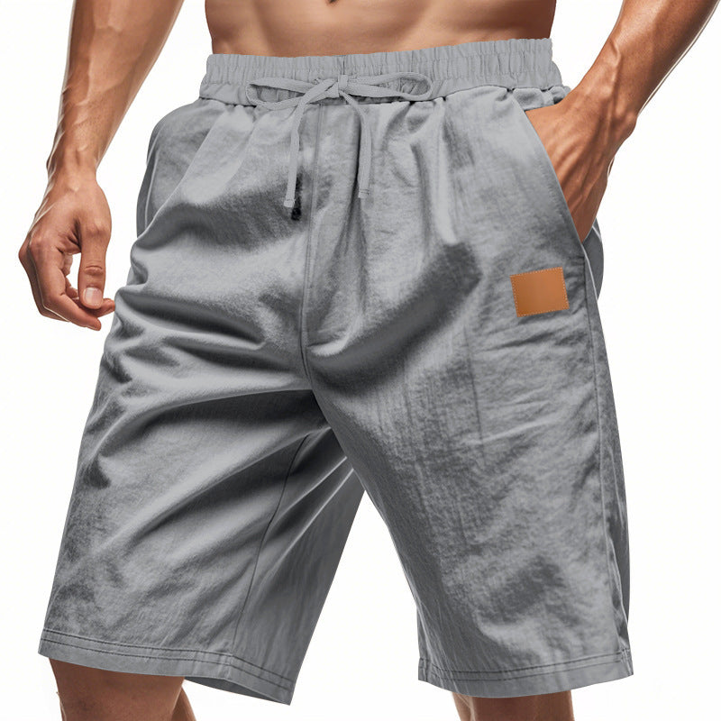 Gray shorts with a brown patch on a white background