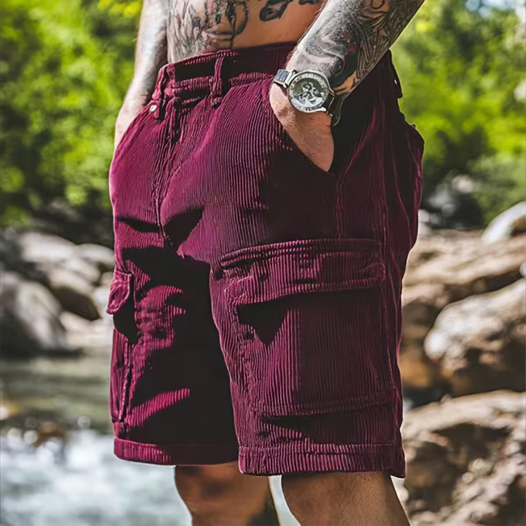Person wearing maroon shorts with a natural background