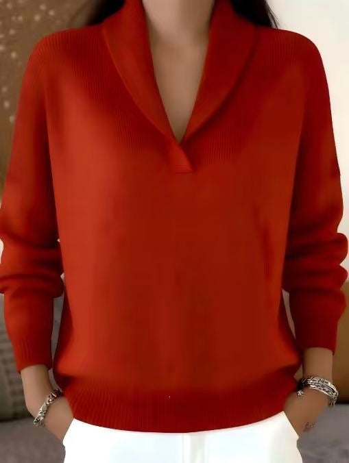 Red sweater worn by a person with a neutral background
