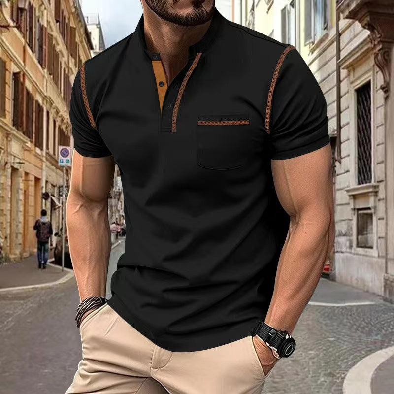 Man wearing a black polo shirt with brown accents on a city street.