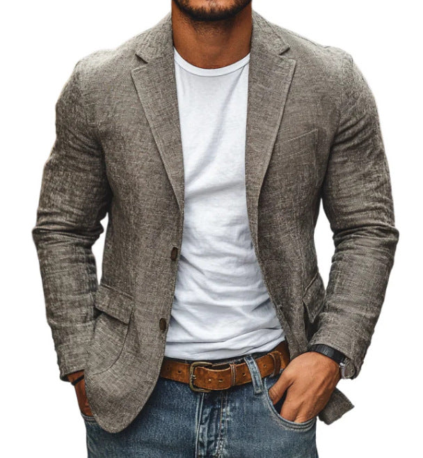 Man wearing a gray blazer over a white shirt with blue jeans on a white background