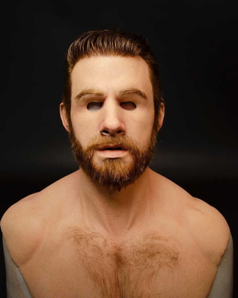 Man with a beard and no shirt on a black background
