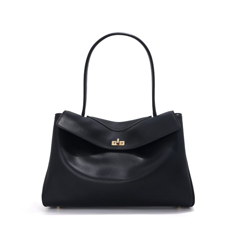 Black handbag with a gold clasp on a white background