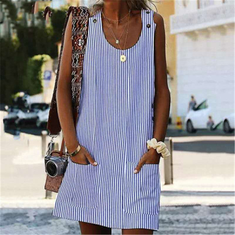 Woman wearing a blue and white striped dress on a street.