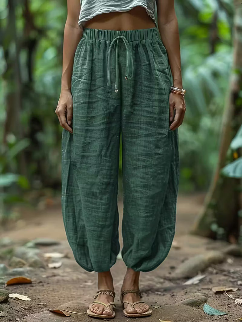 Person wearing green harem pants in a natural setting