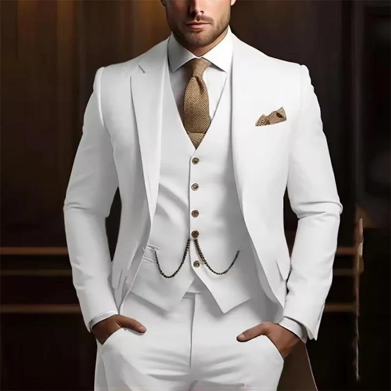 White suit with brown tie and pocket square on a blurred background