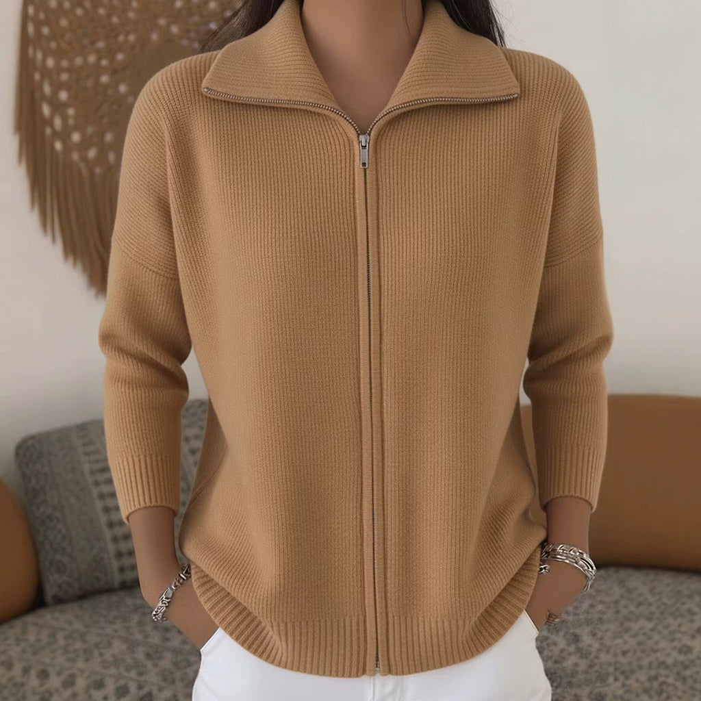 Brown zip-up sweater worn by a person with a blurred background