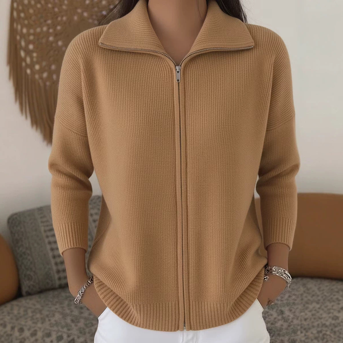 Brown zip-up sweater worn by a person with a blurred background