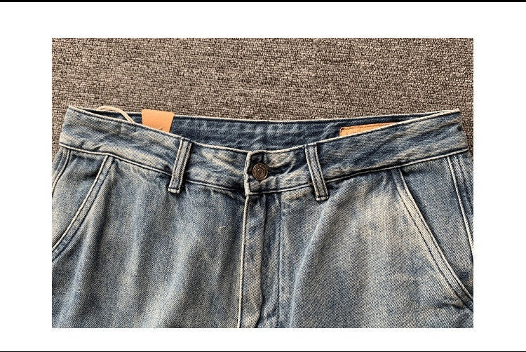 Blue jeans with a belt on a textured surface