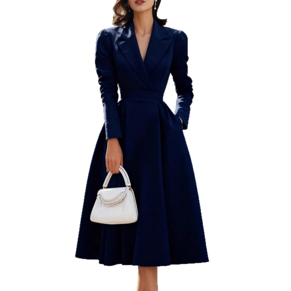 Woman wearing a navy blue dress holding a white handbag on a white background
