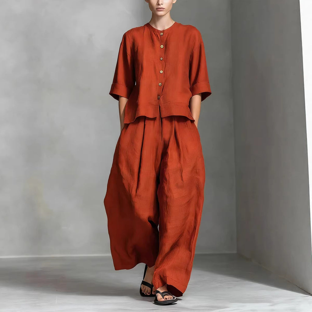 Person wearing a rust-colored outfit against a plain background