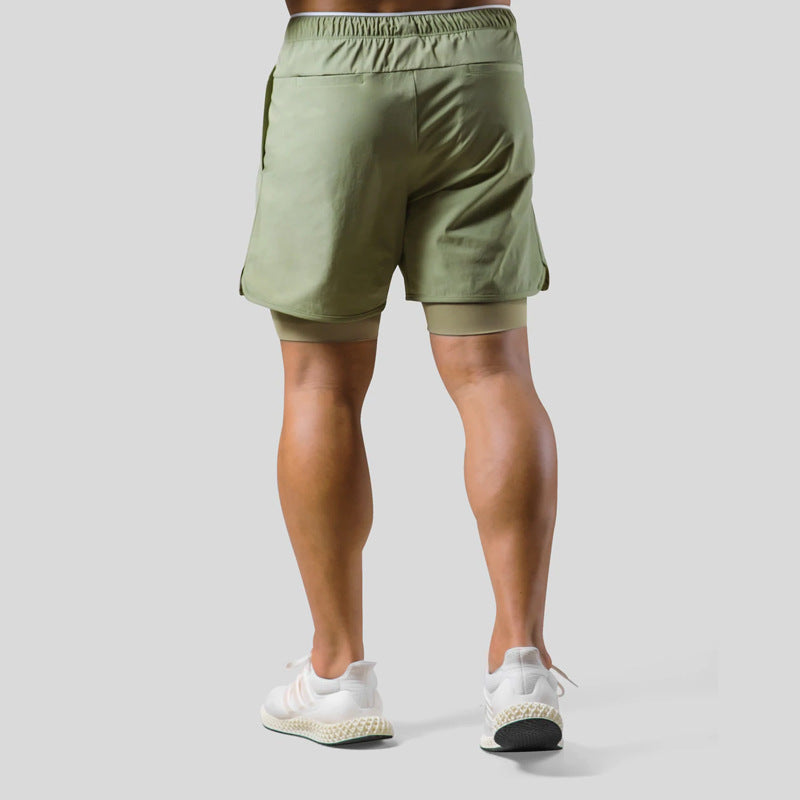 Person wearing green shorts on a plain background