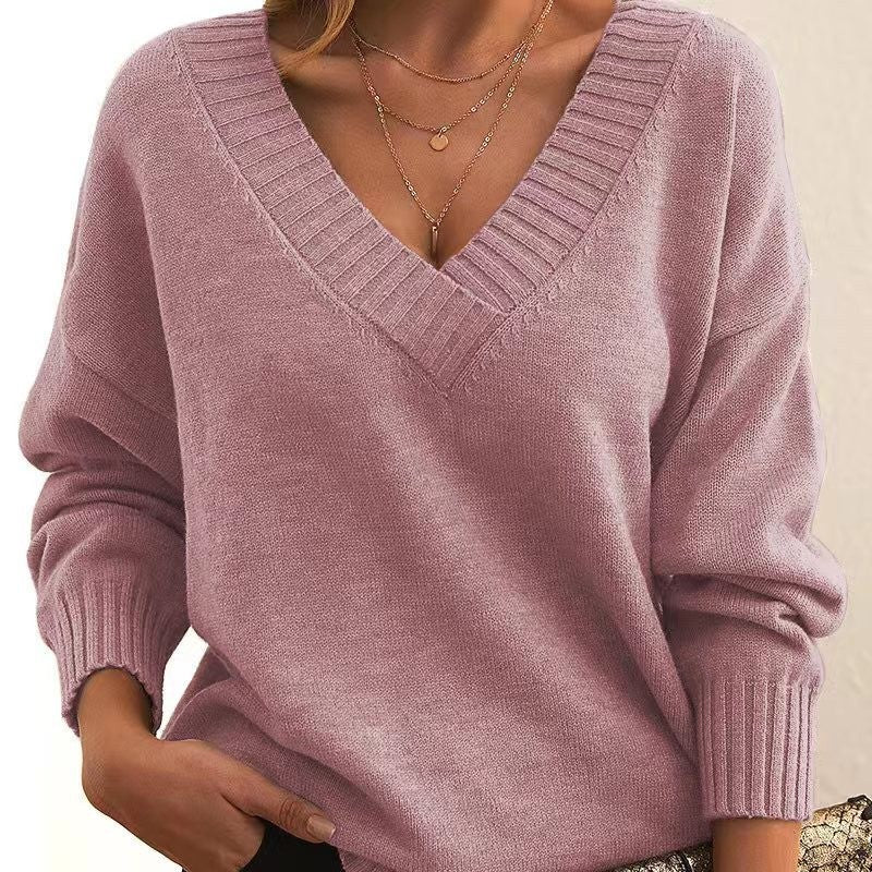 Pink sweater worn by a person on a beige background