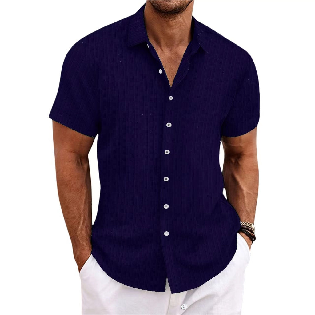 Man wearing a navy blue short-sleeve shirt on a white background