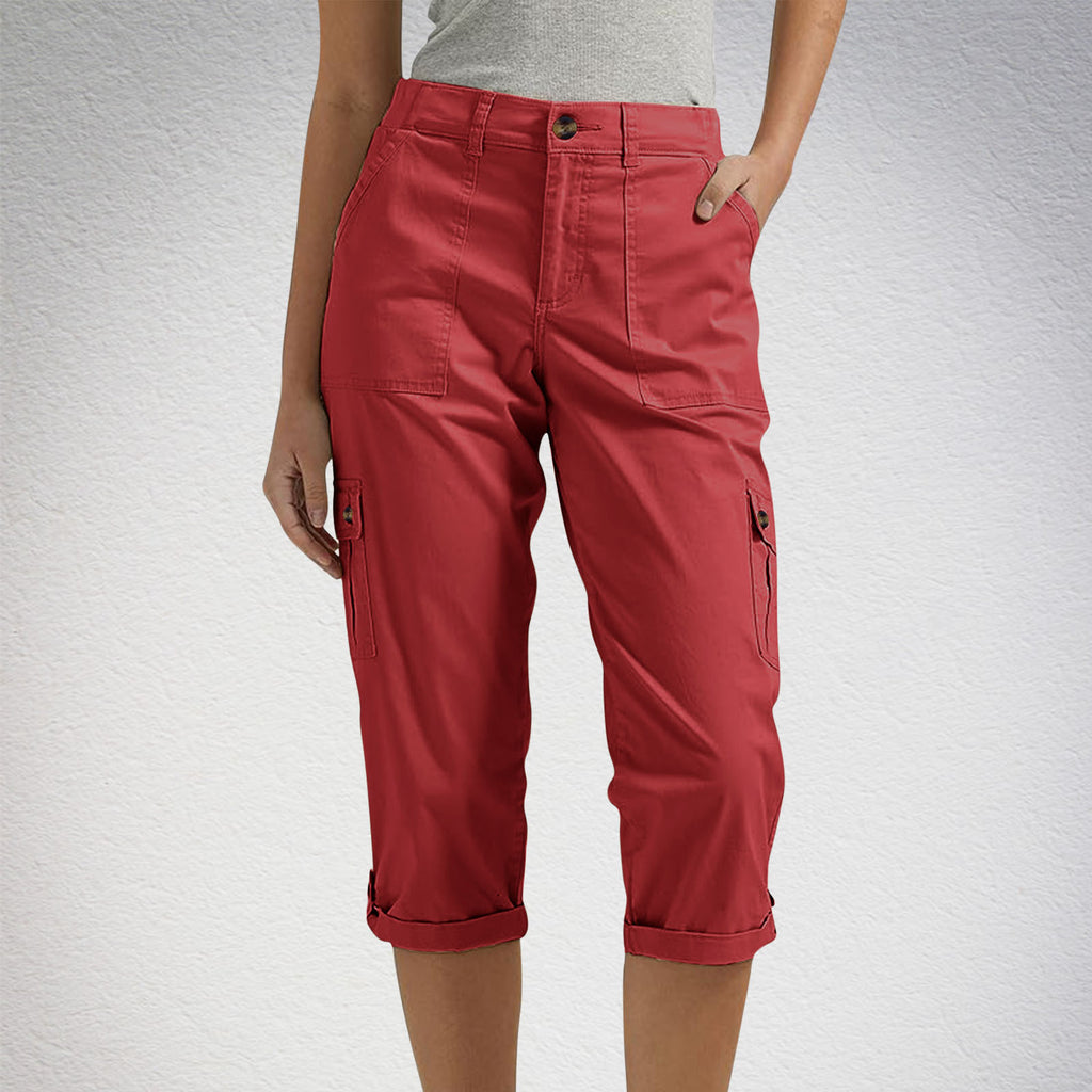 Red capri pants worn by a person on a white background