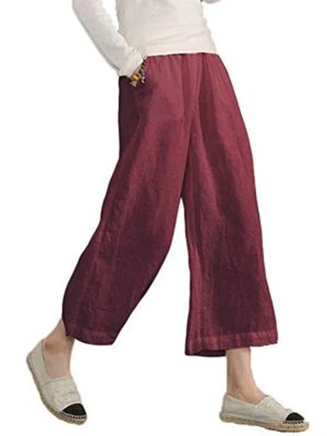 Maroon wide-leg pants worn by a person on a white background