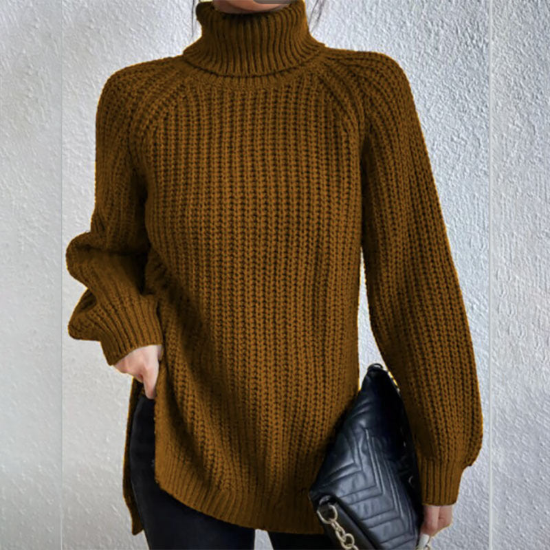 Person wearing a brown knitted sweater against a white wall