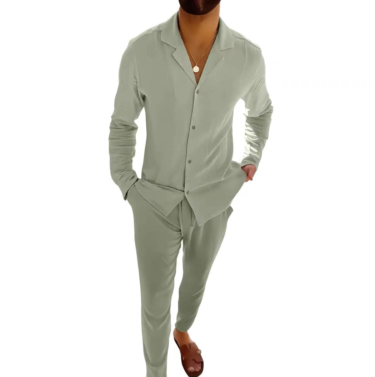 Person wearing a light green suit on a white background