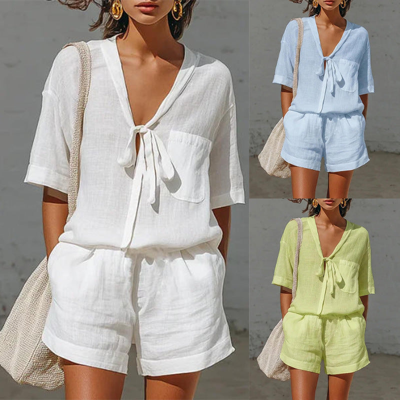 Three women wearing different colored linen outfits with a neutral background