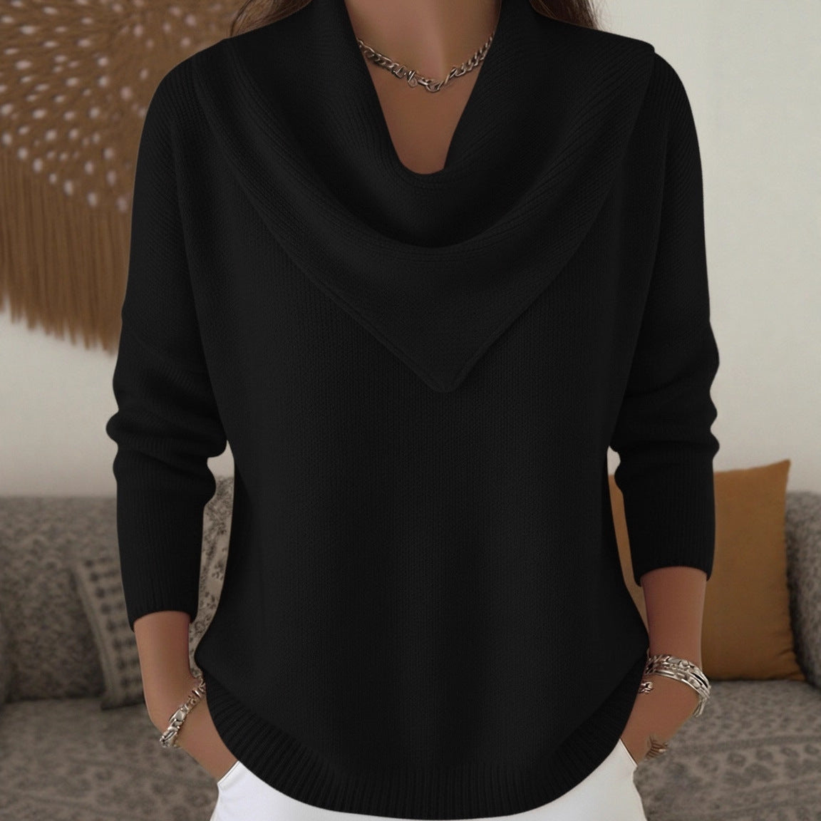 Person wearing a black sweater with a blurred background
