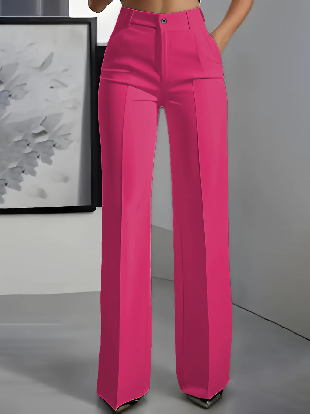 Bright pink pants worn by a person in a minimal indoor setting.