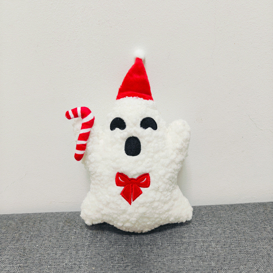 White plush ghost toy with a red Santa hat and candy cane on a gray surface.