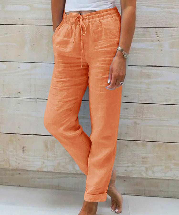 Person wearing orange pants with a wooden background