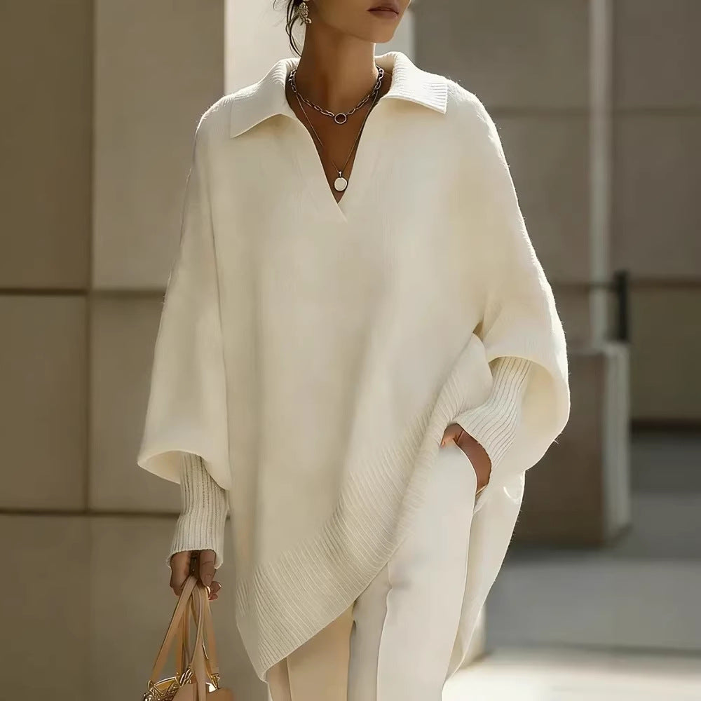 Person wearing a white poncho in an indoor setting