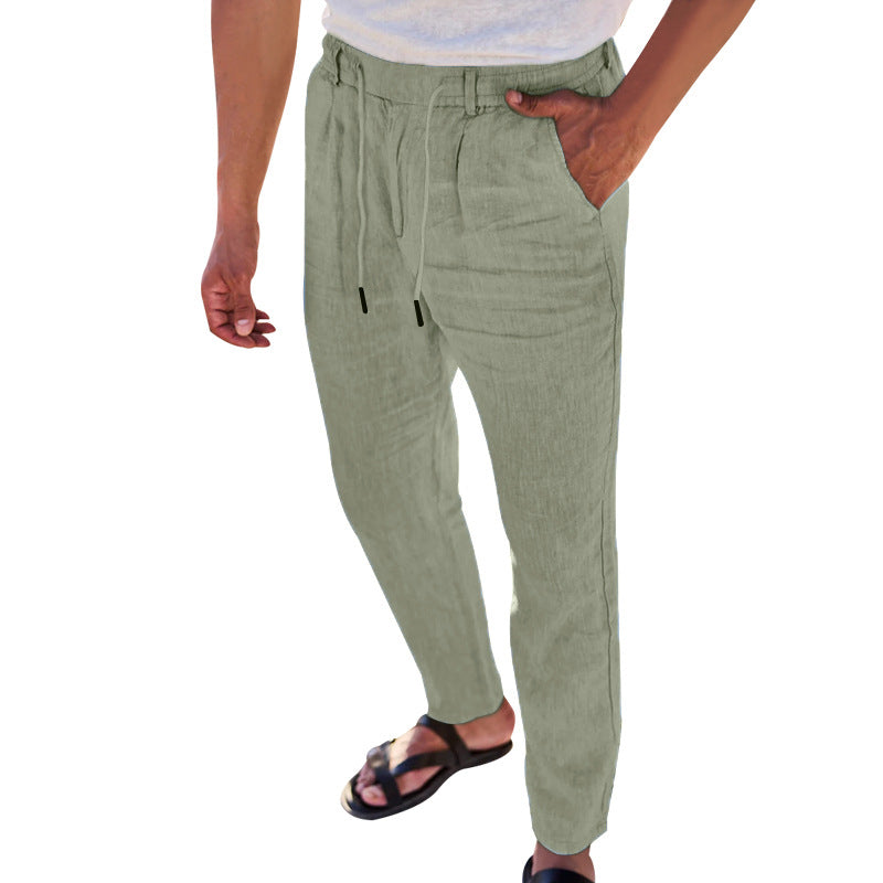 Person wearing light green pants on a white background